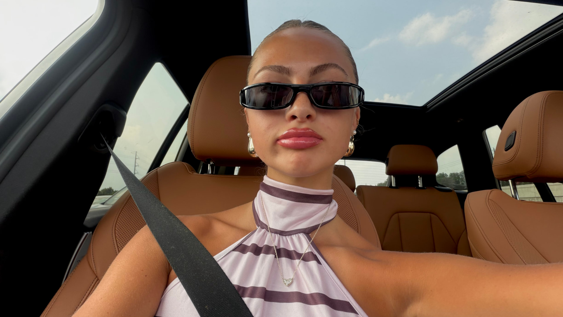 Sadie Rasmussen wearing sunglasses in the car
